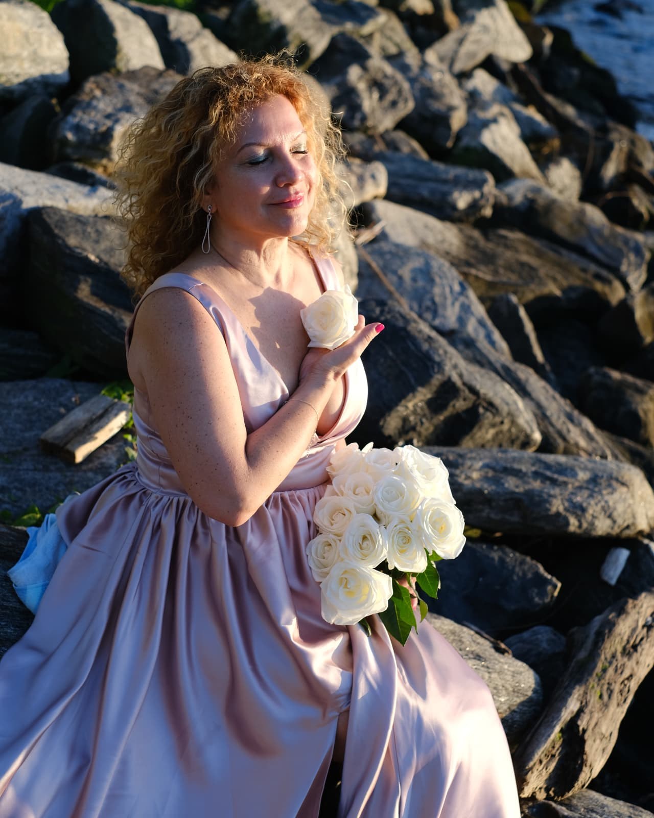 Irina Devi holding white roses